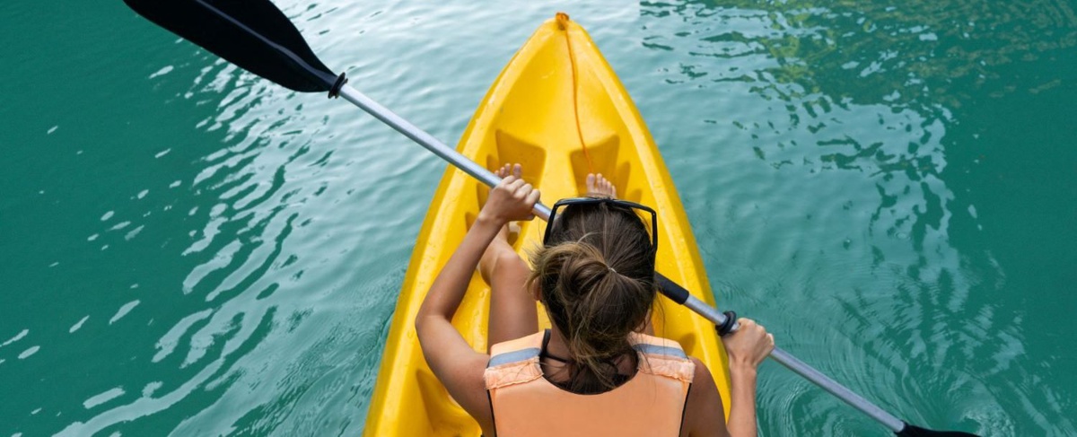 A woman kayaking on a lake