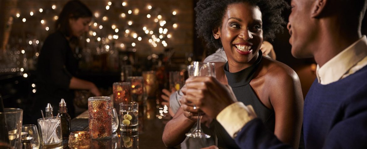 Young romantic couple enjoying drinks at a bar