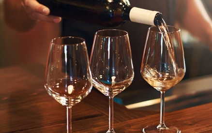 Sommelier fills the glasses during pinot gris wine tasting at a winery on The Urban Wine Trail in Santa Barbara.